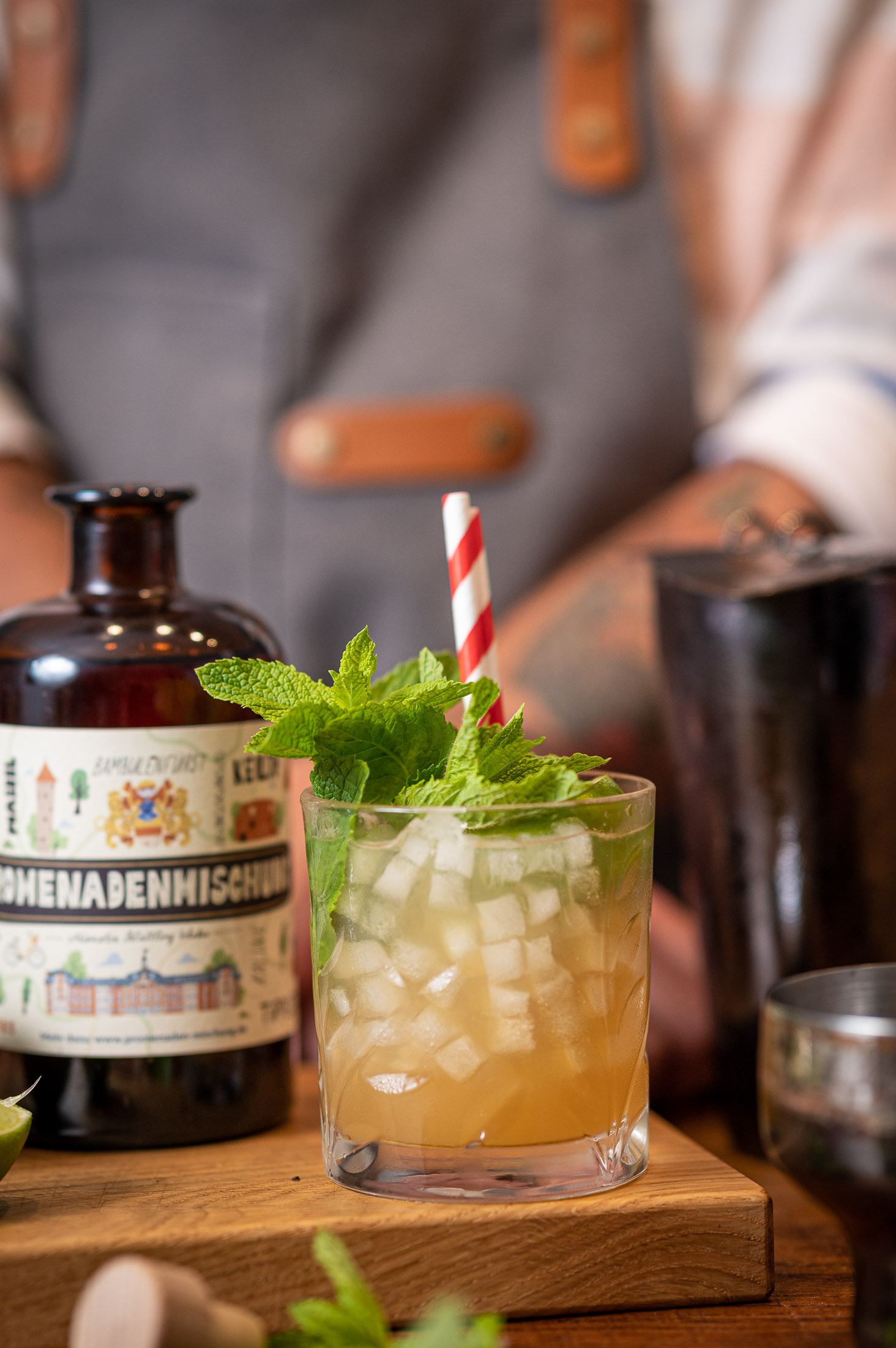 Drink mit Eis und Minze neben einer Flasche Promenadenmischung